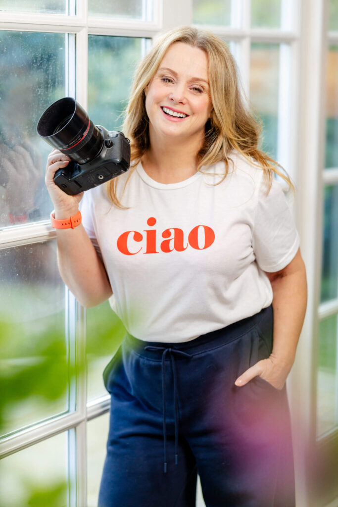 Aphoto of Eddie Judd holding her Canon Camera